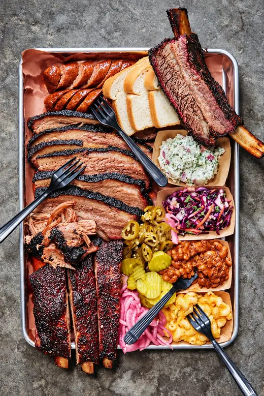 Big Bubba Looo’s smoked meat platter with bread, pickles, slaw and sides